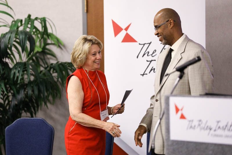 Sarah Lynn Hayes, Behind the Headlines: Building a Community of Trust, receiving her Riley Fellow certificate from Juan Johnson