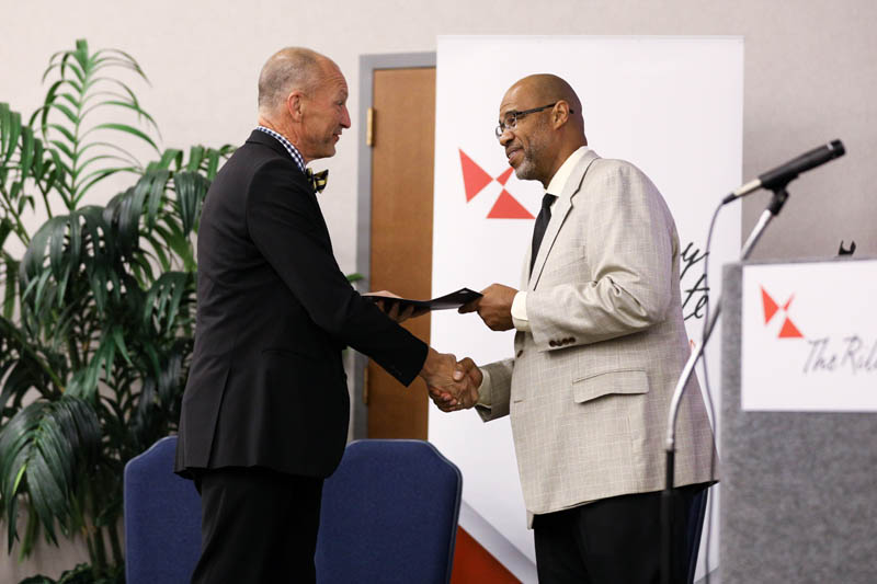 Rusty Infinger, The Home Team, receiving his Riley Fellow certificate from Juan Johnson