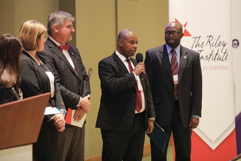 Investing in Islanders (l-r): Nicolle Davies, Eileen Burkhardt, Roger Kirby, Franklin Foster speaking, Clay Middleton