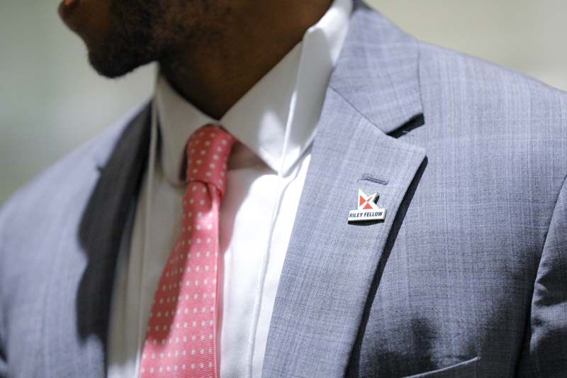 Cory Patterson, A S.E.A.T. at the Table, donning his Riley Fellow pin