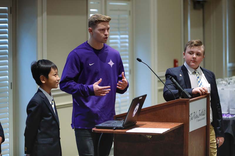 Students from Monaview Elementary School with Cole McLagan, a Furman student soccer player