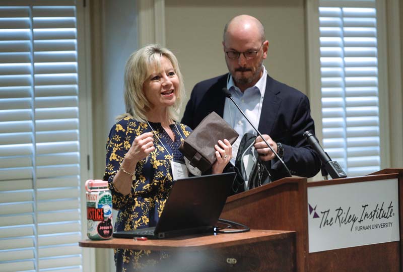 Susan Crowell and Patrick Springhart showing contents of backpack for those released from incarceration, R3