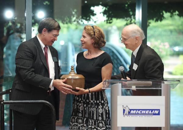 On behalf of the Riley Institute, Don Gordon presents Jean Shifrin with an art piece as a token of gratitude for her hard work on the magazine.