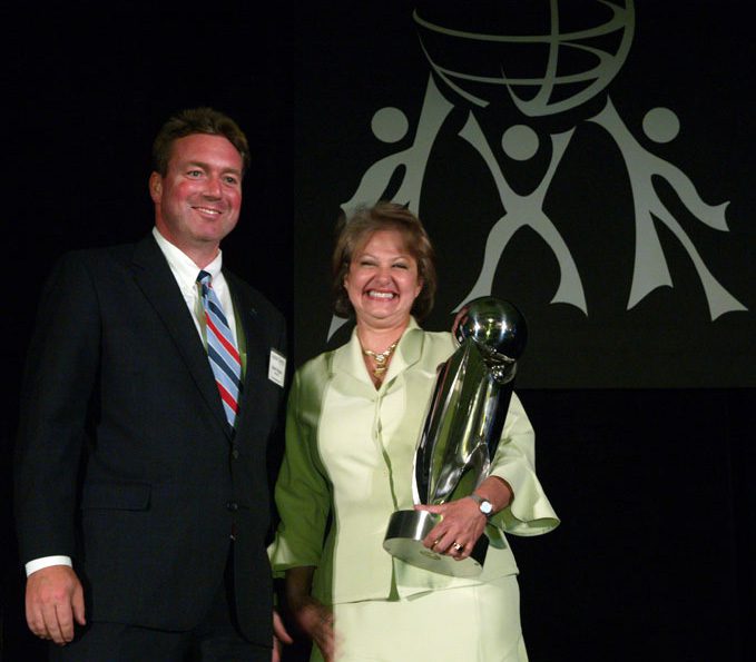 Cristina Schleifer was the recipient of the Outstanding Contribution to International Diversity Award; she is accepting the award from Brian Rogers.