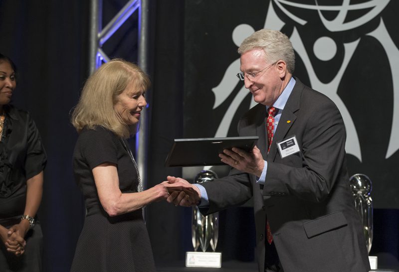 Wally Harris, Denny's Corporation, presenting the Honorable Mention for Outstanding K-12 School Award to Linda Thigpen, who is representing the Washington Center.