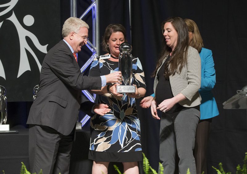 Berea Middle School is the recipient of the Outstanding K-12 School Award. Wally Harris presenting the award to the Principal Robin Mill (center) and the Special Education Department Chairperson Kelly Gregory.