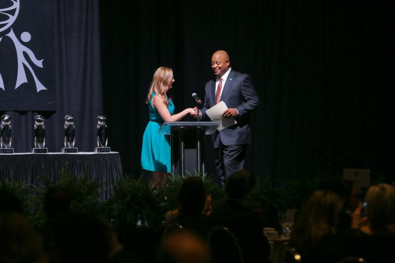 Gabrielle Komorowski welcoming Carlos Phillips, Greenville Chamber's President and CEO, to the podium to share his remarks