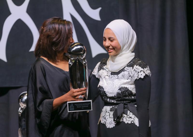 Nika White presenting the Outstanding High School Student award to Roann Abdeladl, a sophomore at Greenville Tech Charter High School