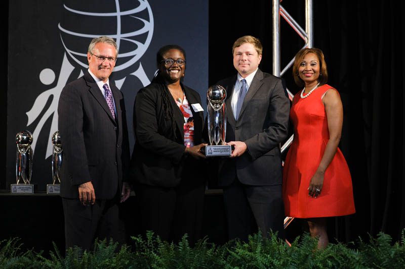 Max Metcalf, BMW Manufacturing Co., presenting the Outstanding Nonprofit Award to Speaking Down Barriers