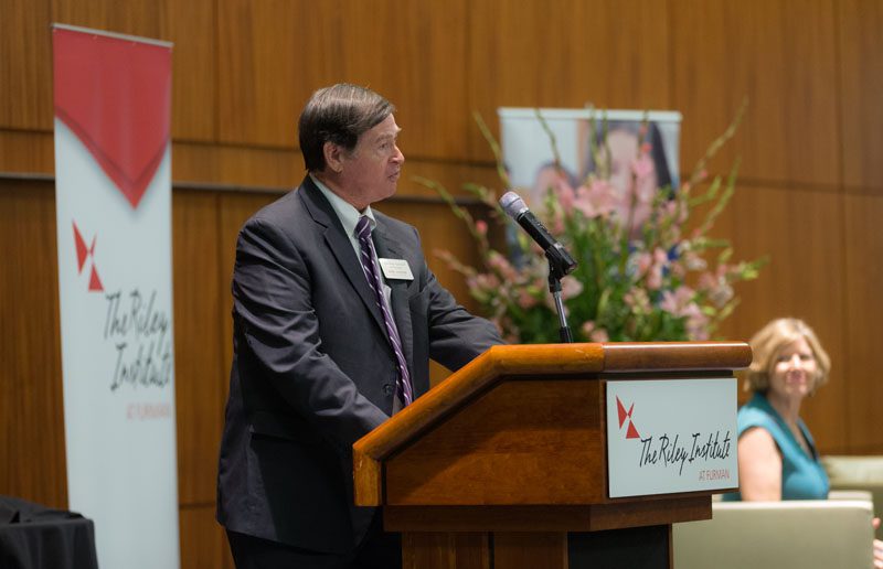 Don Gordon, Executive Director of the Riley Institute, introducing guest speaker Molly Spearman and host Linda O'Bryon