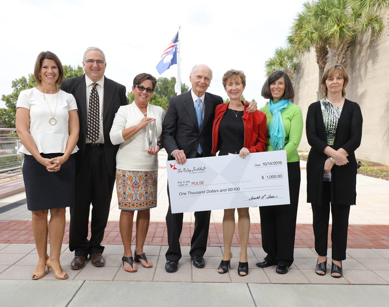 PULSE (l-r): Graham Segars, Dr. Eddie Ingram, Julie Mahn, Secretary Riley, Sharman Poplava, Catherine Romaine-Henderson, and Karen Lee