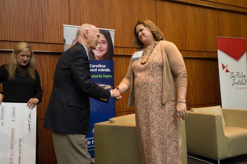 Secretary Riley congratulating Lynn Mann, Innovate! A.J. Whittenberg Elementary School