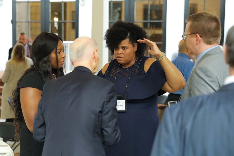 (l-r) Tiyana Glenn, Tyneisha Gibbes, and Brandon Hutton speaking with Secretary Riley