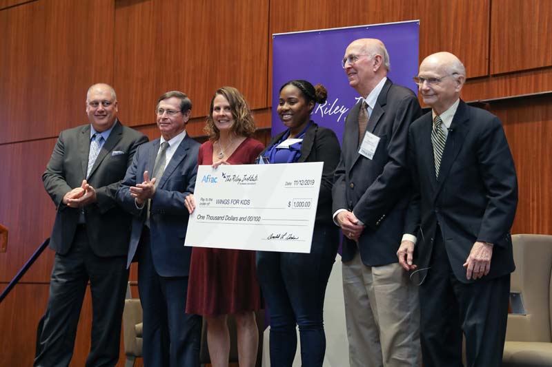 Finalist Wings for Kids accepting their award. (l-r): Jamie Hennessy, Don Gordon, Bridget Laird, Nykia Ramsey, Hayes Mizell and Secretary Riley