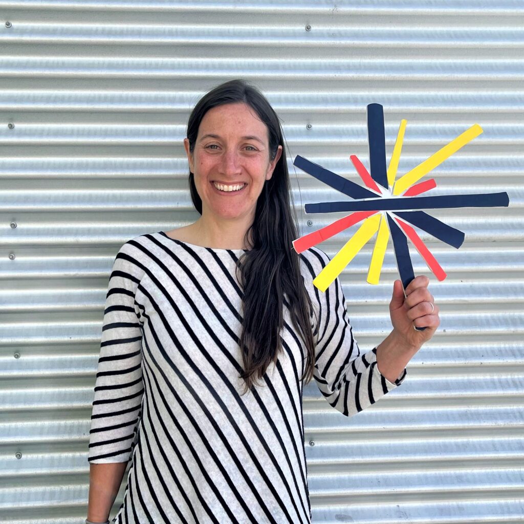 Melanie Hooper with 3D Campfire Alaska logo cutout in her hand