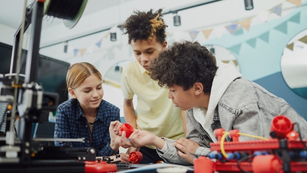 Three teenagers working on a science project.