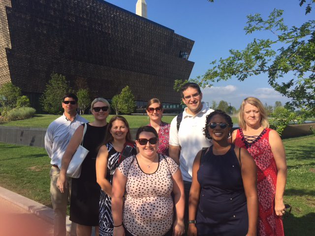 In front of the National Museum of African American History and Culture: Row 1: (l-r) Sabrina Cheek, Crystal Whitaker; Row 2 (l-r) Jonathan Clayton, Anne Moore, Stephanie Peagler, Jennifer Wike, Anthony Bufis and Melissa Brown