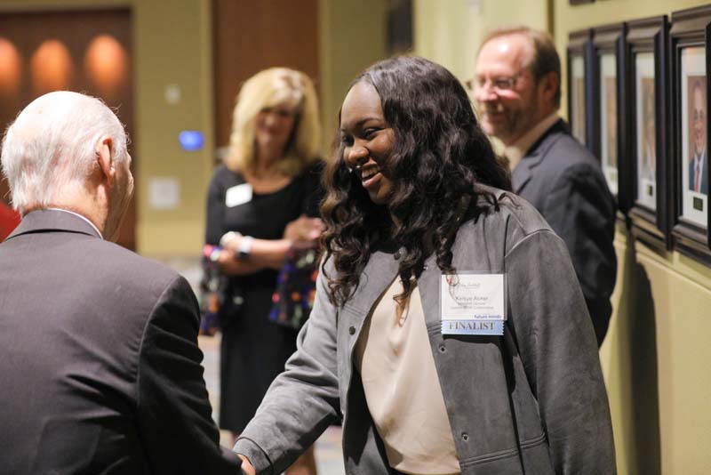 Secretary Riley greeting Kelsye Acker, a member of Finalist South Carolina's Coalition for Mathematics & Science (SCCMS)