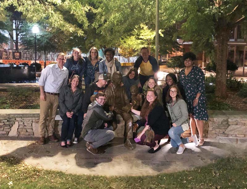 The Fellows pose for a photo by Secretary Riley's sculpture located in front of the Peace Center in downtown Greenville