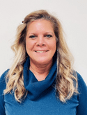 Head shot of a woman in a blue turtleneck.