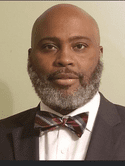 Head shot of a man in a suit.