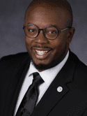 Head shot of a man in a suit.
