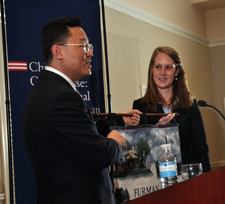 Advance Team member, Emily Patterson, presenting the gift to the Minister