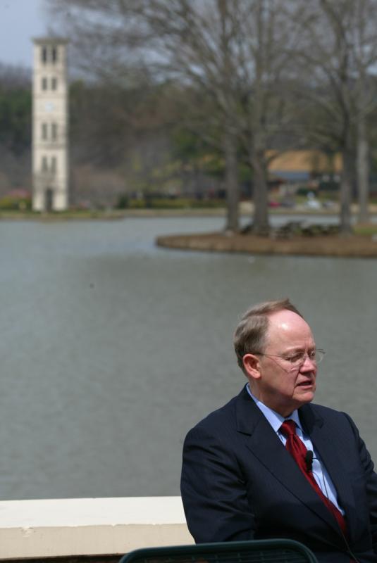 McConnell speaking with students by the Furman lake
