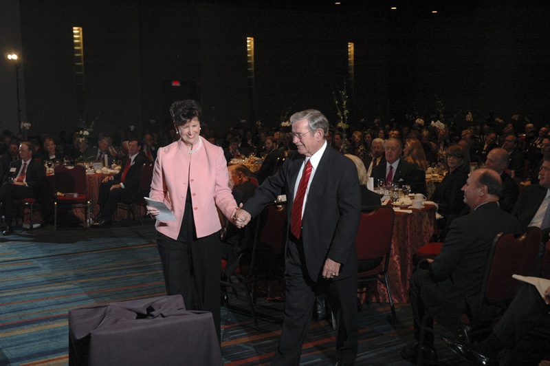 Paula Harper Bethea escorting Senator Leatherman to the stage to receive his award
