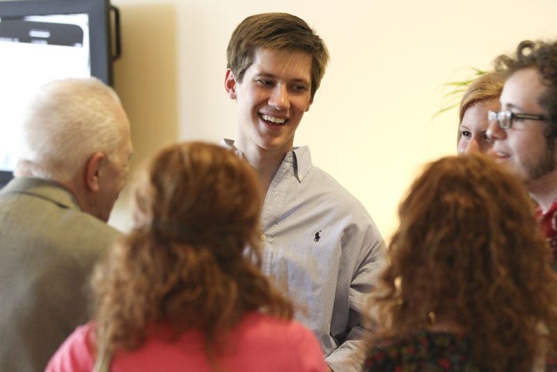 More students conversing with Richard Benedetto