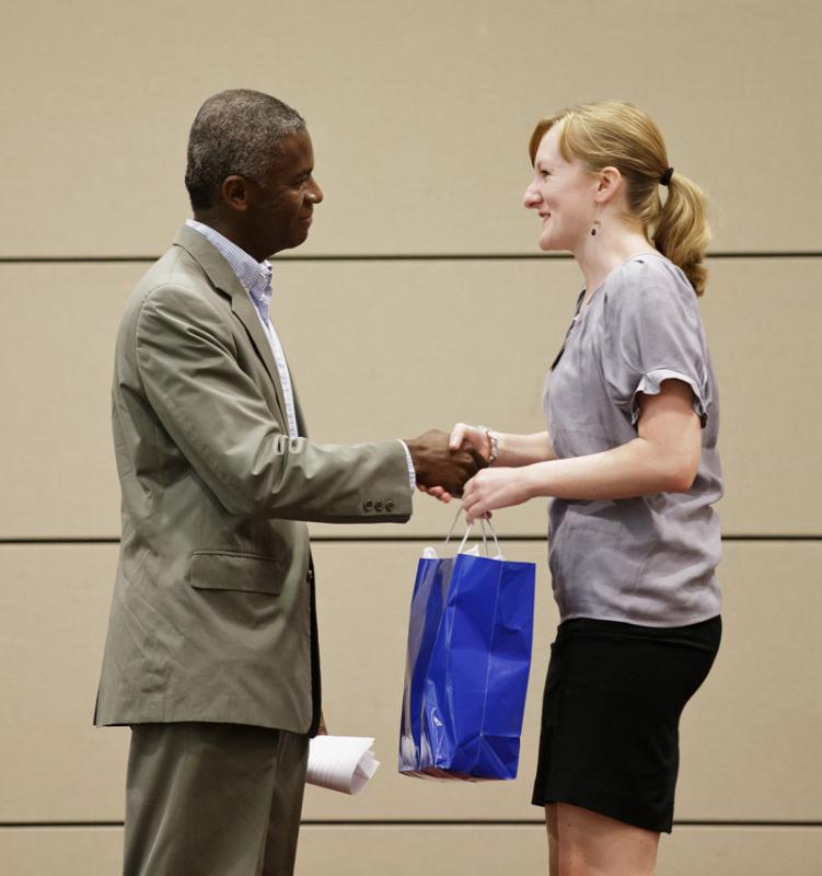 Amanda Michalski presenting a gift of appreciation to John