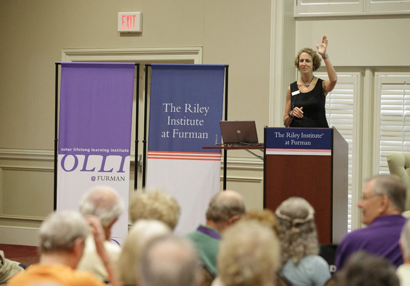 Lucy Woodhouse, director of Osher Lifelong Learning Institute, welcoming speakers and guests
