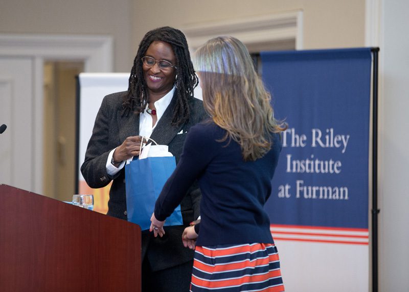 Lee Bolton, Advance Team member, presenting a gift of appreciation to Ambassador Sanders
