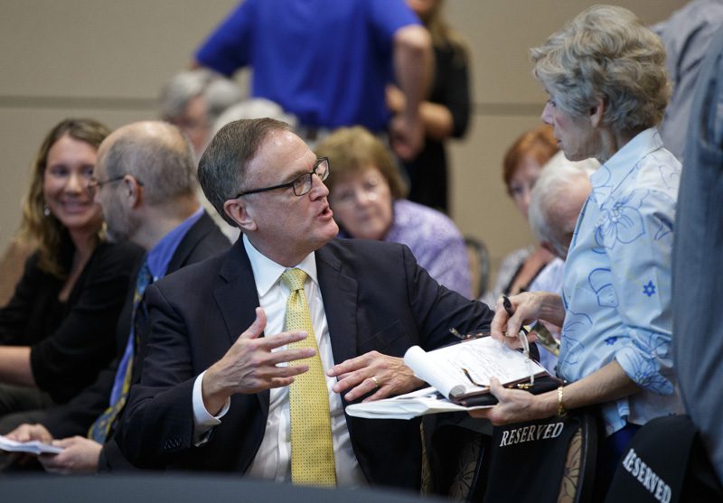 Hugh Greene continues the conversation with guests after his address
