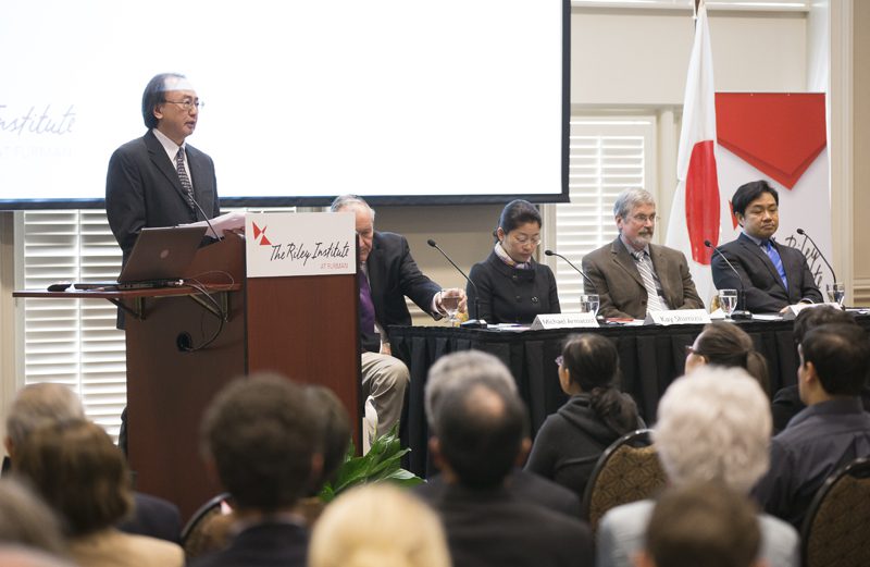 Shusuke Yagi introducing the panelist who will be discussing 