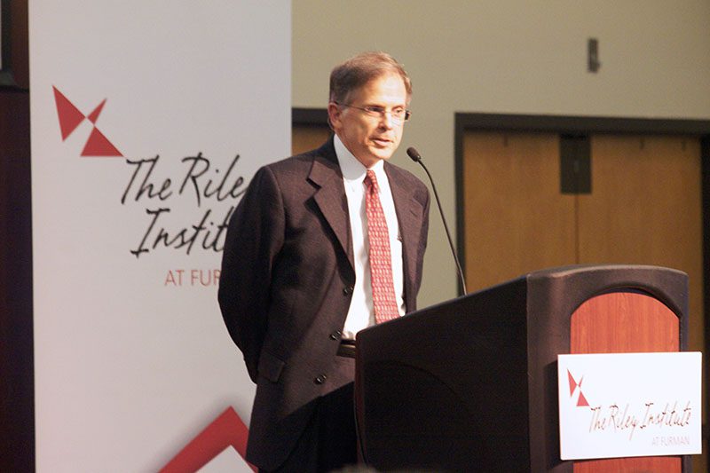 Furman professor of Political Science Mike Bressler introducing Andrew Michta
