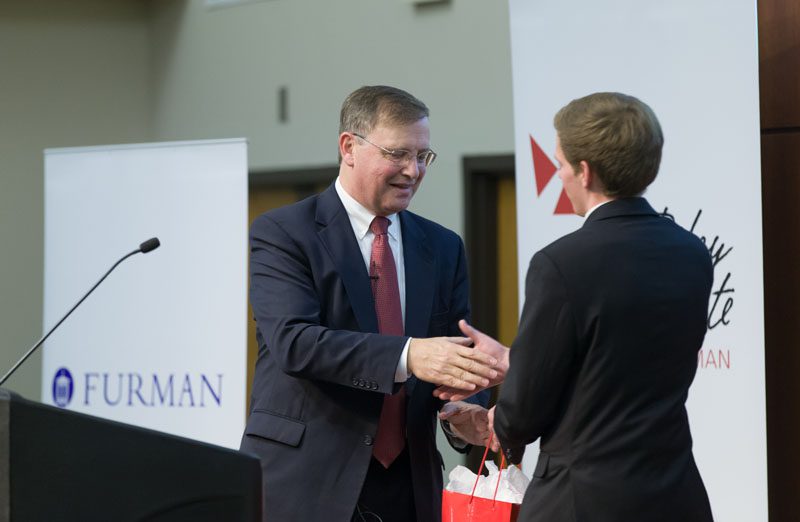 Advance Team member Noah Zimmermann presenting a thank you gift to Chuck Rosenberg