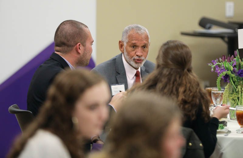 Charles Bolden, former head of the National Aeronautics and Space Administration (NASA), interacting with students at his table