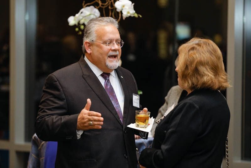 Thomas Hudson speaking with a guest