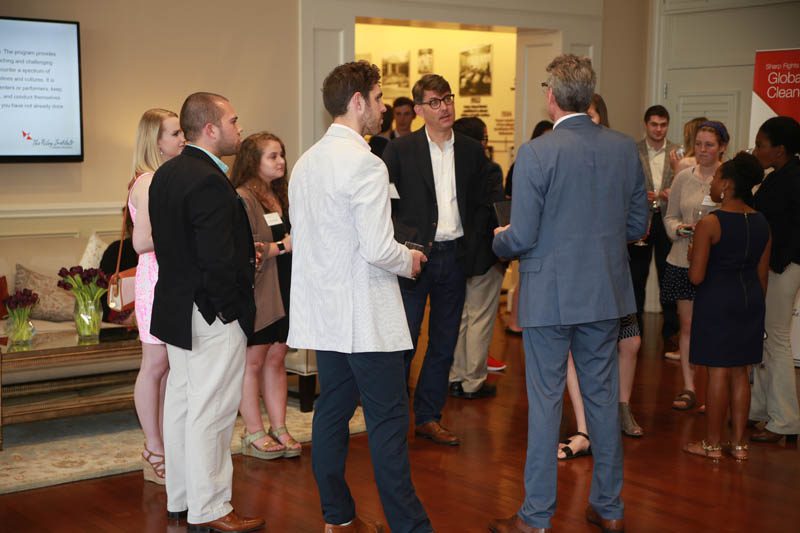Jeffrey Ball engaging with student scholars at a reception
