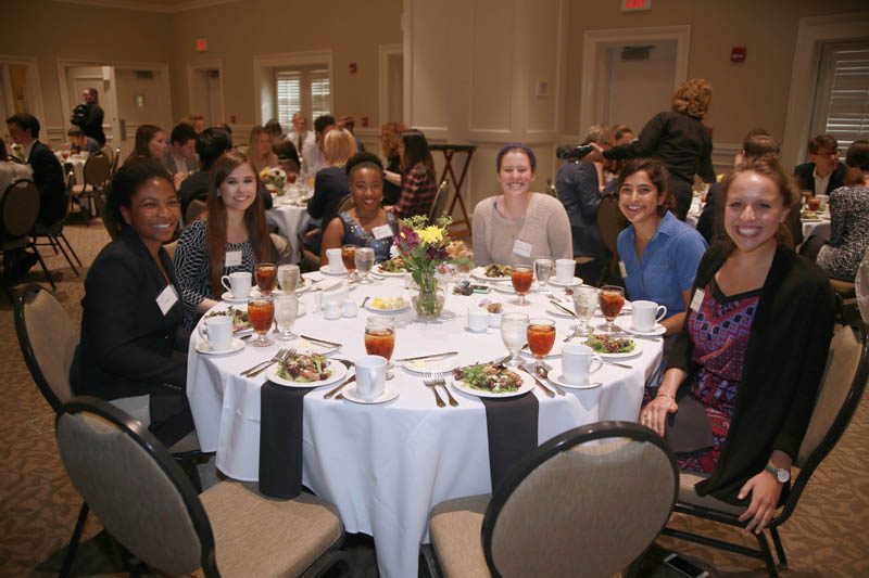 Student scholars at dinner with Jeffrey Ball