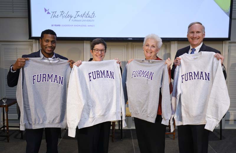 (l-r): Jason Terrell, Beth Niblock, Deborah Malac and Eric Spitler proudly displaying their Furman sweatshirts