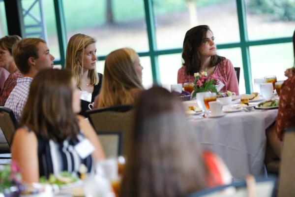 Scholars listening while Jill Fuson makes remarks about the evening