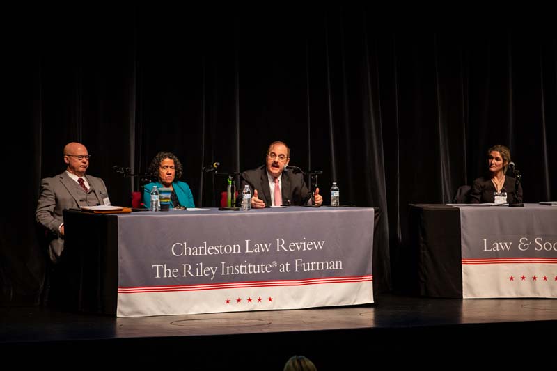 (l-r) Tom Mullikin, Professor of Environmental Law, Charleston School of Law; Astrid Caldas, Senior Climate Scientist, Union of Concerned Scientists; Harry Kelso, Deputy General Counsel for Environment, Energy & Installations, Department of Defense, speaking; and moderator Allyson Haynes Stuart, Co-Director of Academic Success and Professor of Law, Charleston School of Law