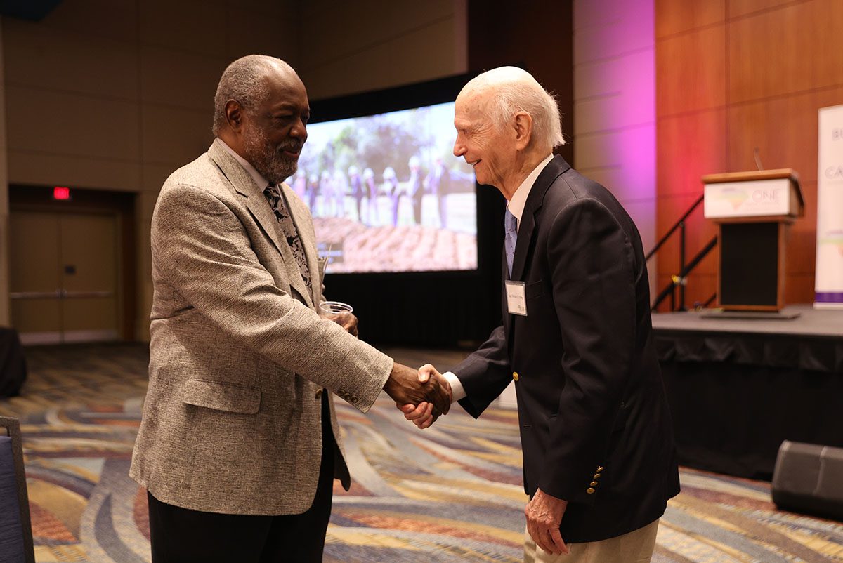 Roland Gardner, CEO of Beaufort-Jasper-Hampton Comprehensive Health Services, shakes hands with Sec. Riley. Gardner will receive the Riley-Wilkins OneSouthCarolina Award for Excellence in Civic Leadership in 2023. 