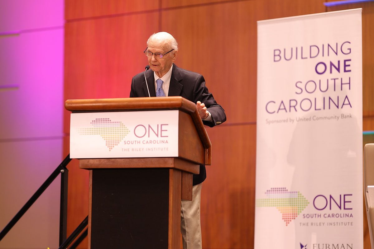 Sec. Dick Riley greets the crowd at the start of the forum. 