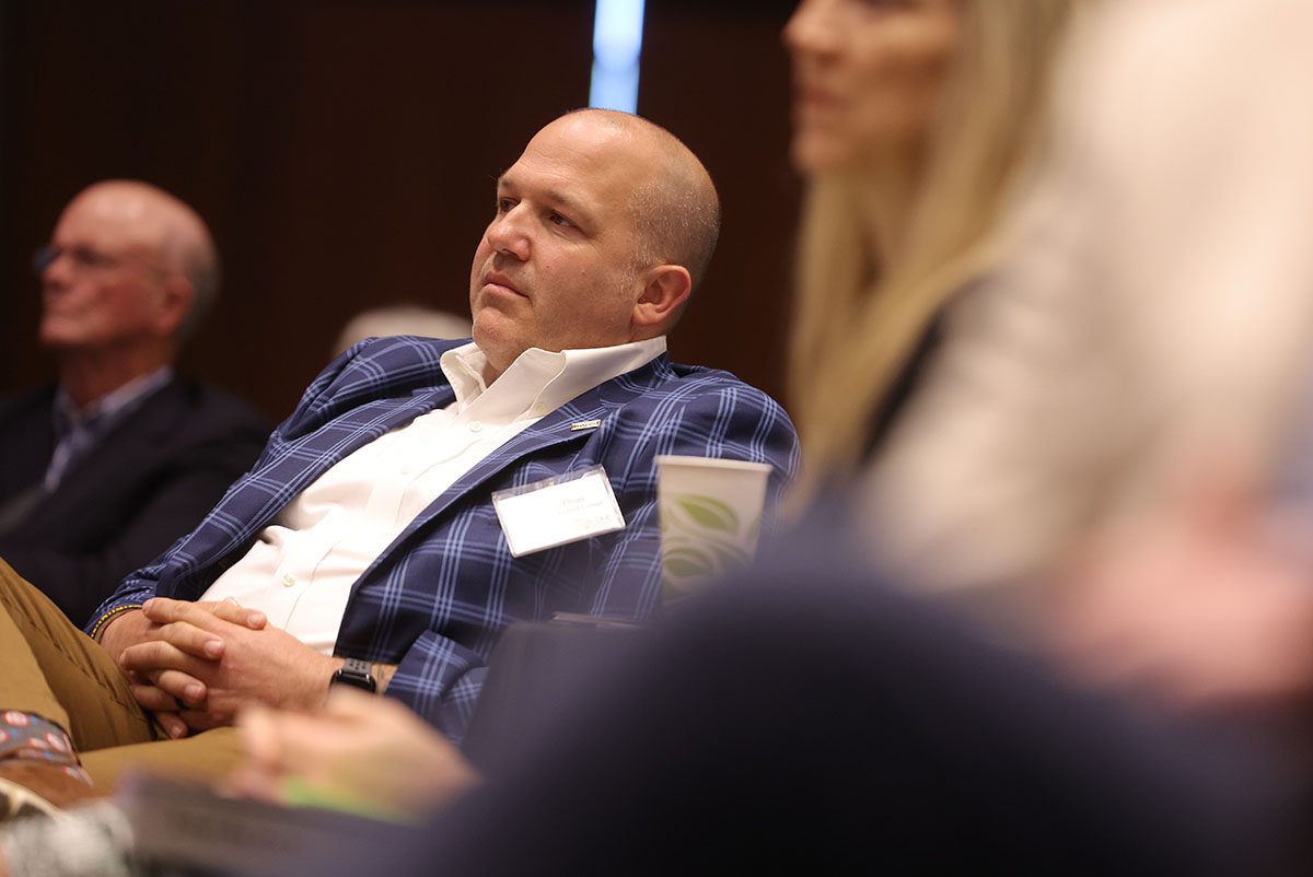 Curt McPhail, former project manager for the Northside Development Corporation, looks on at the speakers.
