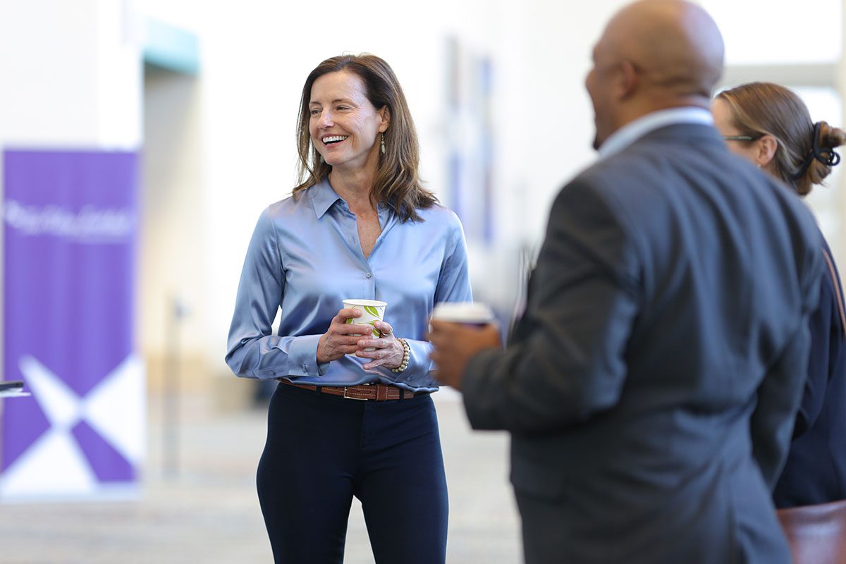 Riley Institute deputy director Jacki Martin chats with eventgoers before the start of the forum. She moderated two panels at the event.