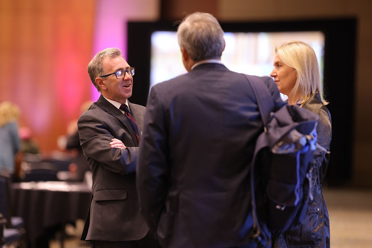 Phil Feisal, president of Spartanburg Regional Medical Center, chats with others prior to the start of the forum. He spoke on a panel about building an opportunity infrastructure.