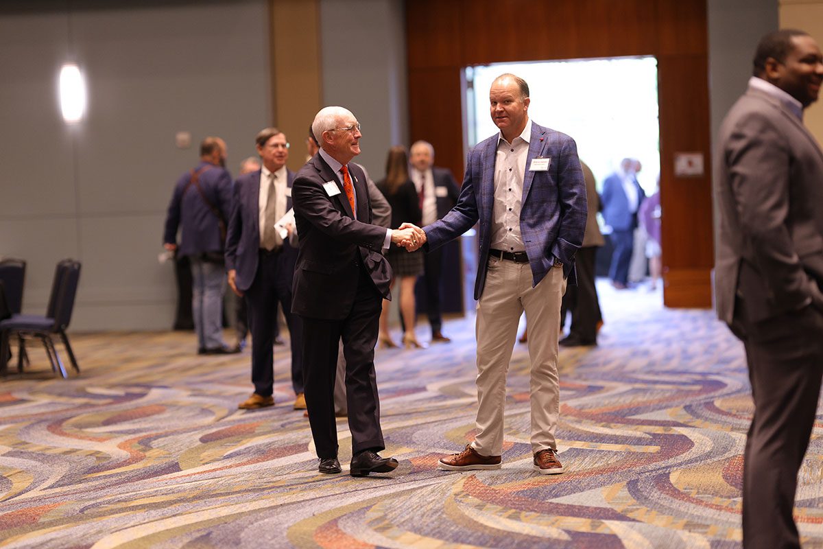 Gary Clary, Clemson University chief judge, shakes hands with Shannon Stephens of United Community Bank. 